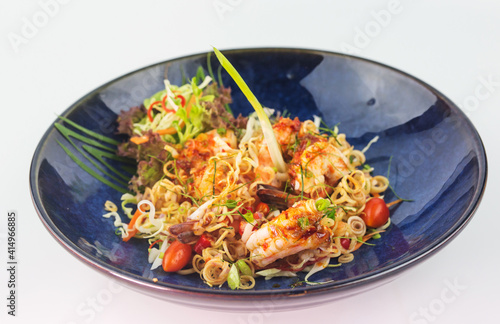Close up Thai Cuisine shrimp salad with lemongrass in blue plate on white background