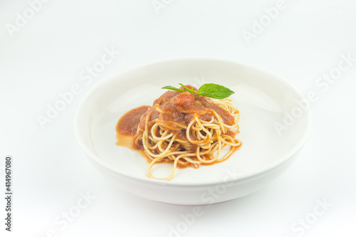 Spaghetti with tomato sauce in white plate on white background