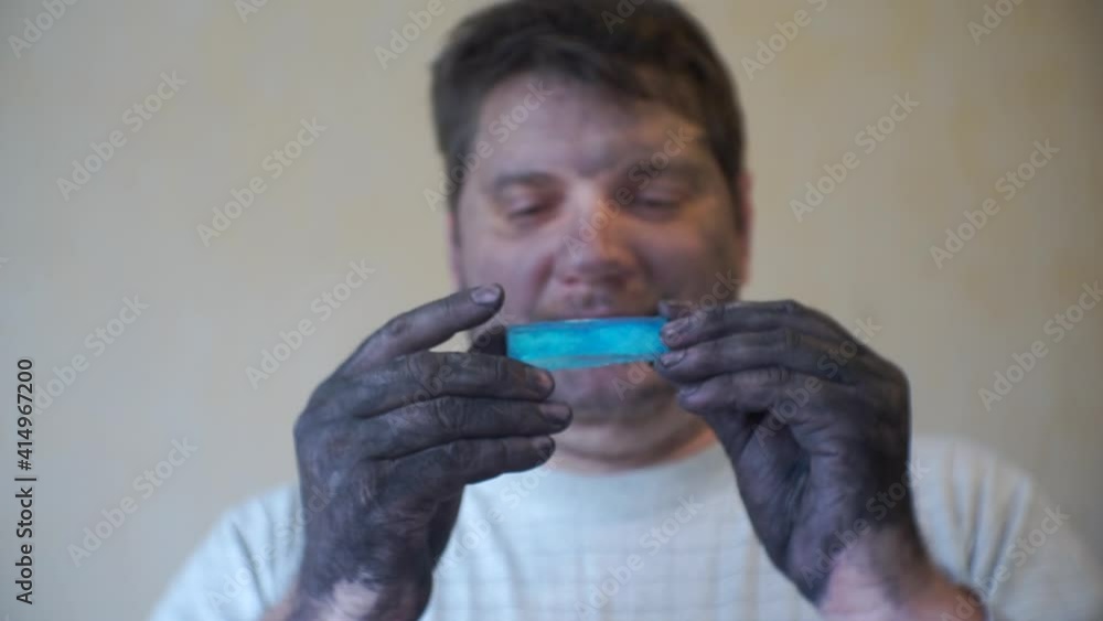 dirty man holding a large crystal in his hands.mining.business concept