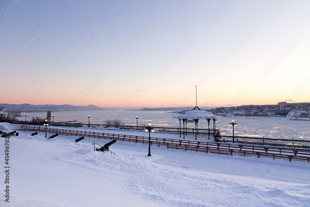 South-east view of famous Dufferin Terrace in the old town seen with a fresh coat of snow during a blue hour winter morning, Quebec City, Quebec, Canada