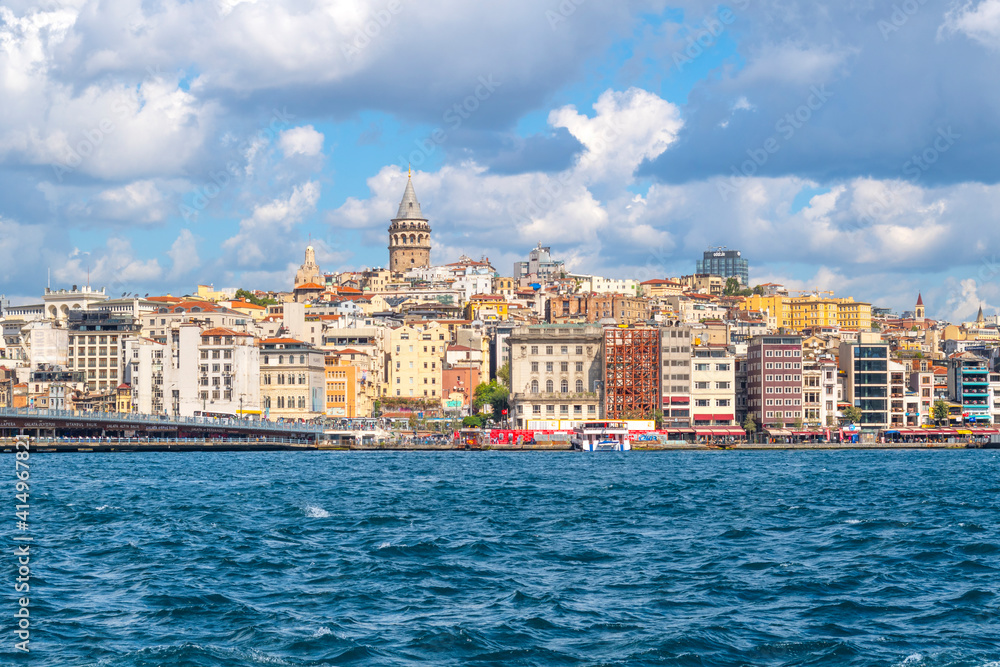 A view of the ancient Galata Tower, the Galata Bridge, the Bosphorus river and skyline of Istanbul, Turkey at the Golden Horn.