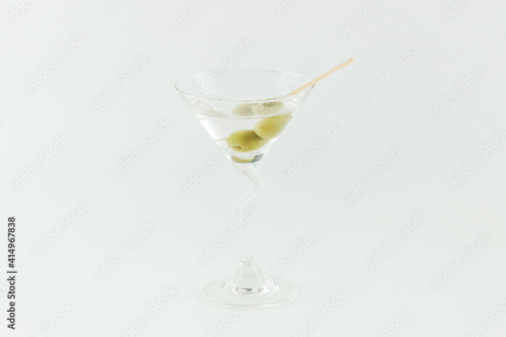 Martini cocktail with green olives on white background Martini cocktail with green olives on white background