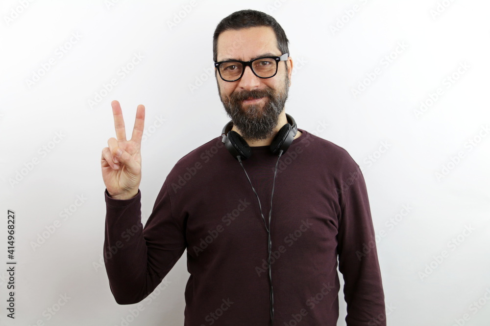 Man with beard showing and pointing with fingers number two while smiling confident and happy. Man with beard showing and pointing with fingers number two while smiling confident and happy.