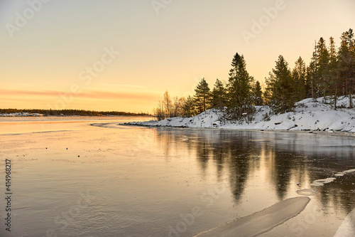 sunrise over the frozen lake in winter