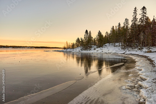sunrise over the frozen lake in winter