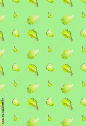 A pattern with green lettuce leaves on a light green background. Grocery background.
