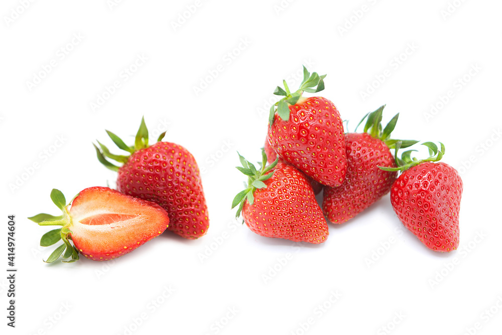 Ripe fresh organic strawberries in a pile, whole and half with leaves isolated on white background. Ripe fresh organic strawberries in a pile, whole and half with leaves isolated on white background.