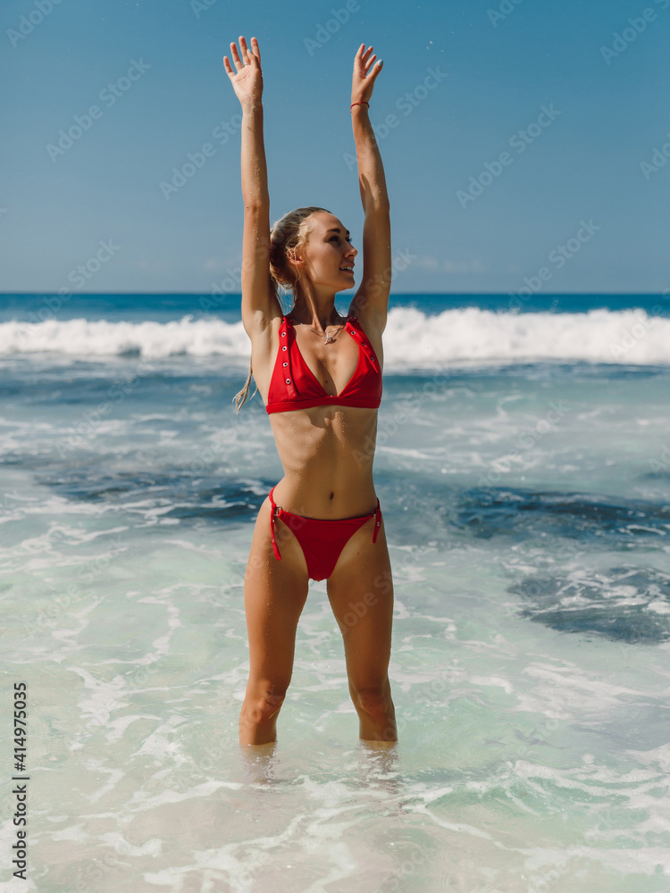 Obraz premium Attractive happy woman in swimwear enjoy summer at beach