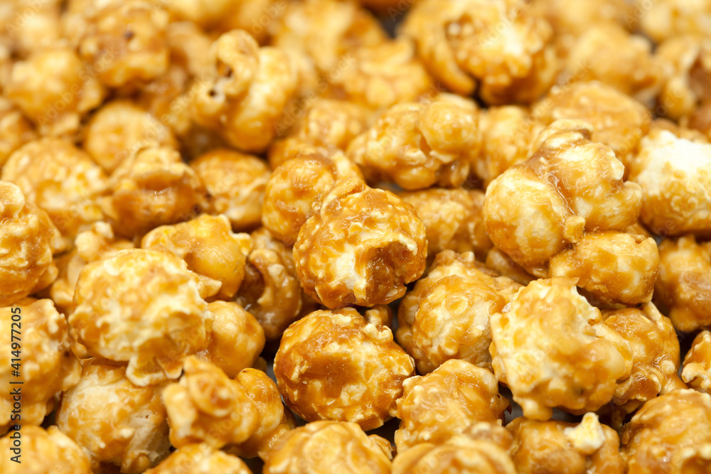 Popcorn in caramel close-up. Macro photography. Caramelized popcorn. Popcorn background. Popcorn in caramel close-up. Macro photography. Caramelized popcorn. Popcorn background.