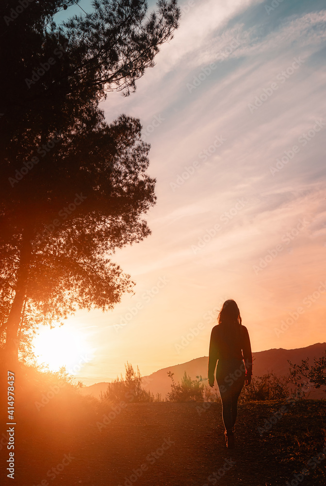 Young Girl training hiking in the nature at sunset
