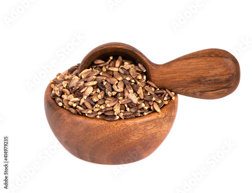 Milk Thistle seed in wooden bowl and spoon, isolated on white background. Silybum marianum, Scotch Thistle or Marian Thistle.