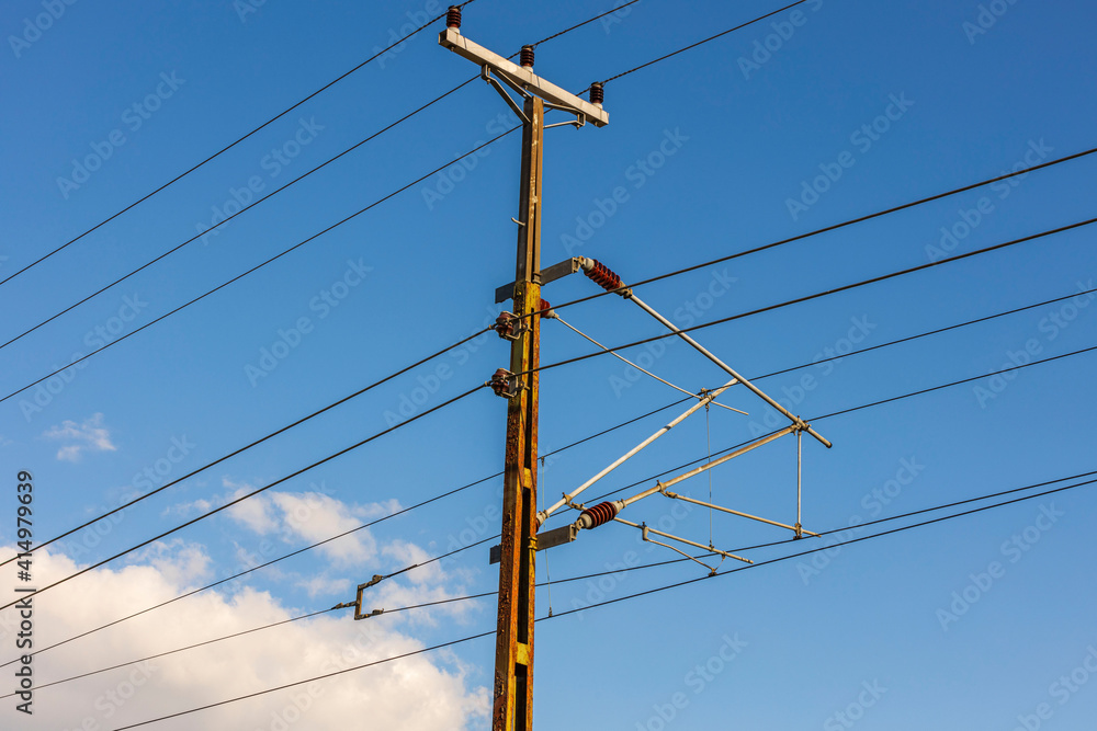 Close up view of power line on blue sky and white clouds background.