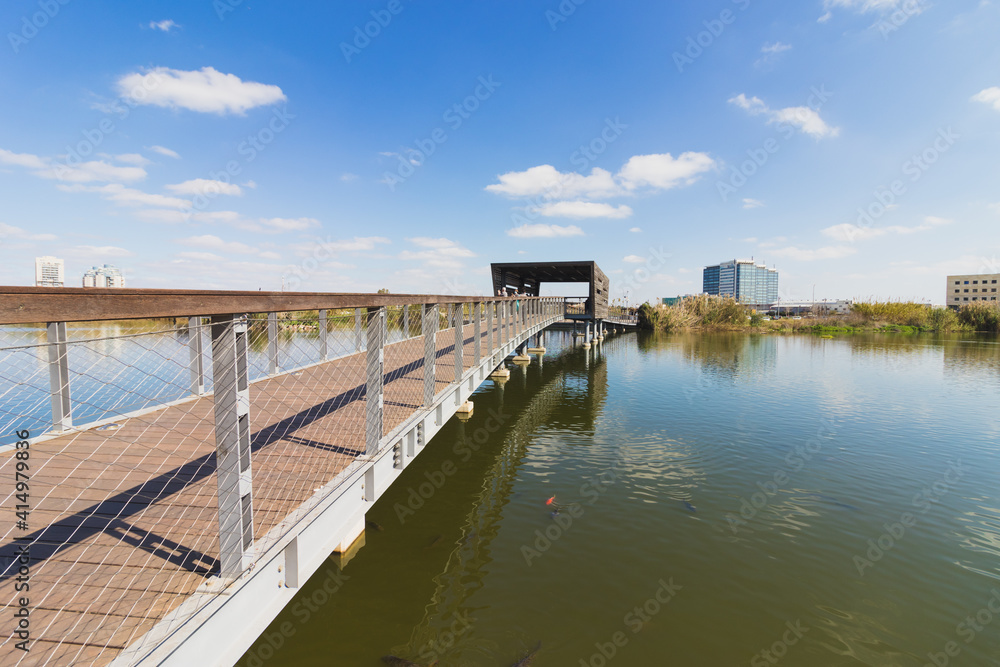A large water pool with a wooden promenade on it, in the ecological park in Hod Hasharon - Israel