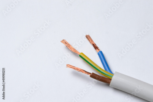 the stripped three-core wire lies on a light background. close-up