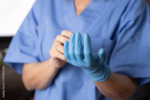 nurse putting on protective gloves