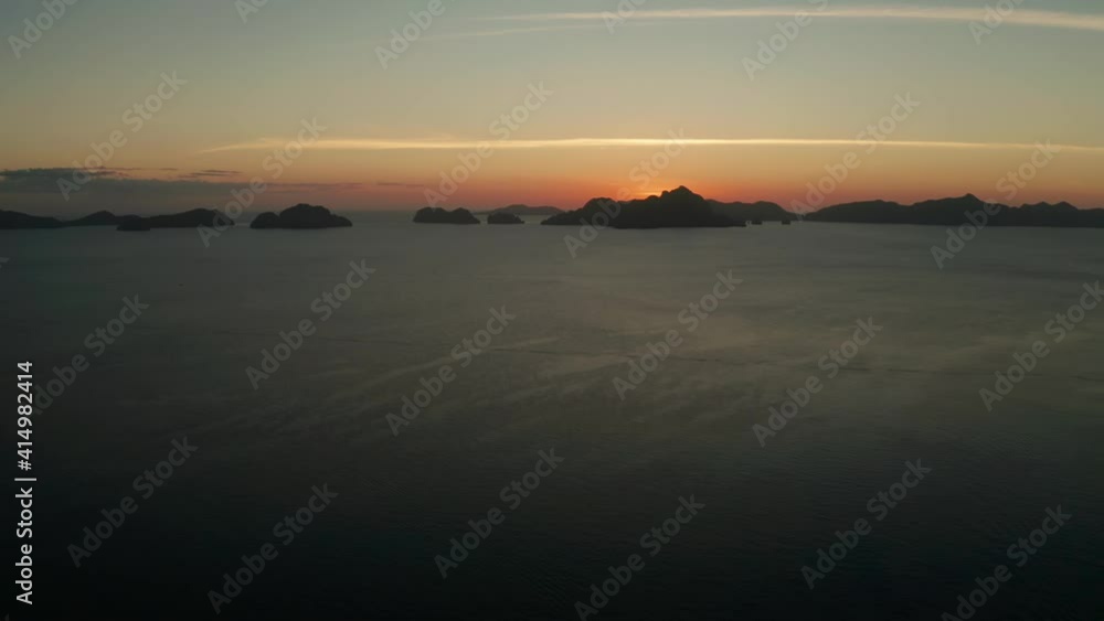 aerial view tropical sunset over the sea background of mountains. El nido, Philippines, Palawan. seascape with tropical islands at sunset time. Summer and travel vacation concept aerial view tropical sunset over the sea background of mountains. El nido, Philippines, Palawan. seascape with tropical islands at sunset time. Summer and travel vacation concept