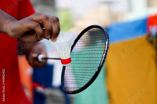 Badminton player holding racket with badminton feather.. © saif71