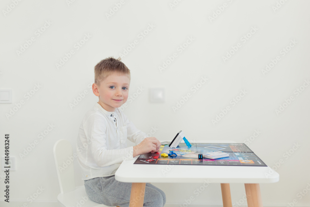 The man's father, playing a board game with her young son spend time together The man's father, playing a board game with her young son spend time together