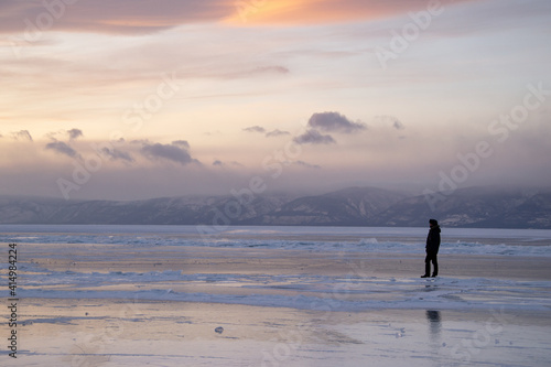 silhouette of a person on the frozen lake 