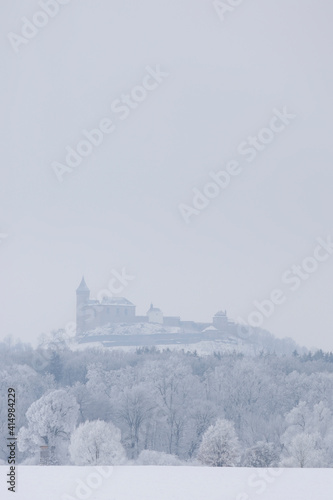 Kuneticka hora castle in the middle of a frozen forest