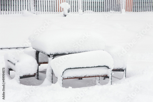 Wallpaper Mural Snow drifts lie on the table and benches in the snow-covered courtyard of the city. Winter city landscape. Torontodigital.ca
