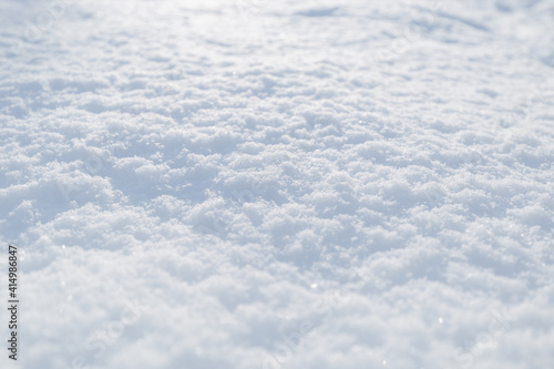 Snow texture. Top view of the white snow. Background with copy space. Winter time