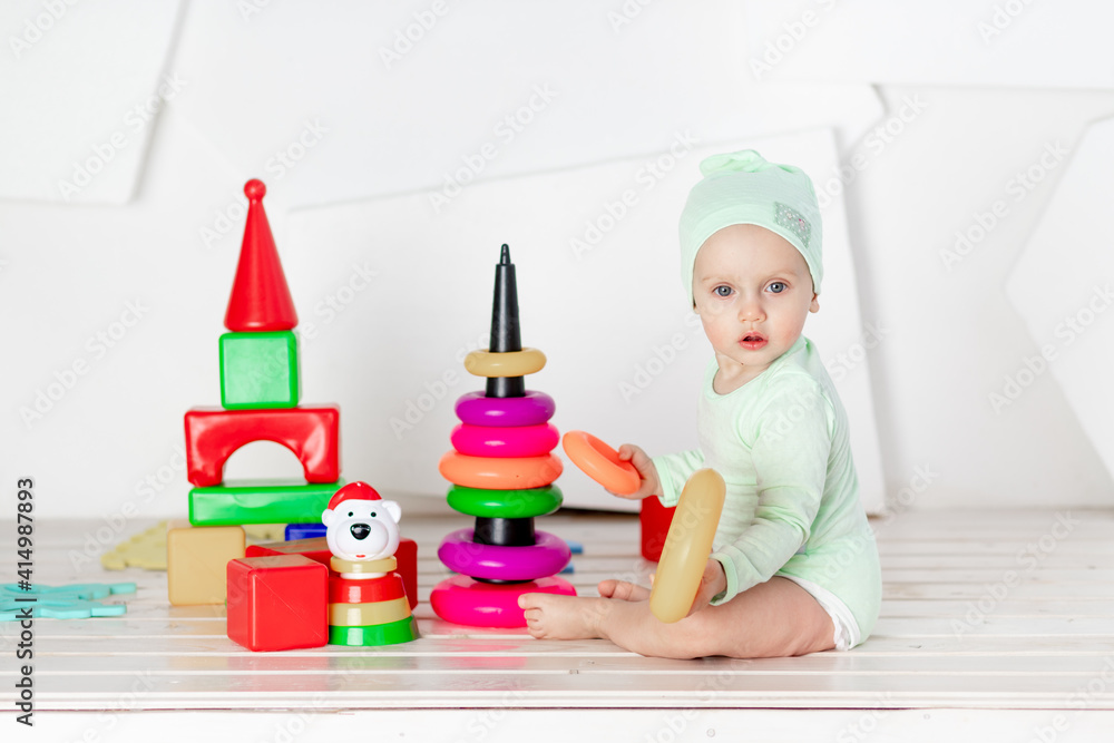 toddler playing with colorful cubes in the children's room at home, the concept of development and leisure of toddlers toddler playing with colorful cubes in the children's room at home, the concept of development and leisure of toddlers
