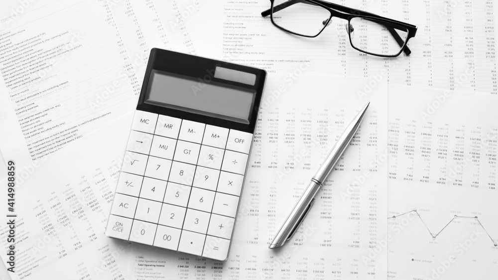 Calculator with pen on stock market analysis. Concept of Business, Finance and Audit research. Calculator with pen on stock market analysis. Concept of Business, Finance and Audit research.