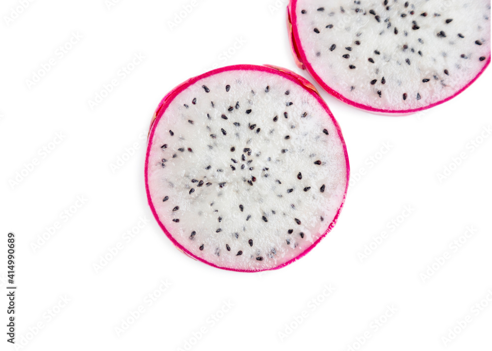 Two slices of dragon fruit with white flesh on a white background. The pink-skinned pitaya fruit is low in calories, rich in essential vitamins and minerals, and contains dietary fiber. Two slices of dragon fruit with white flesh on a white background. The pink-skinned pitaya fruit is low in calories, rich in essential vitamins and minerals, and contains dietary fiber.