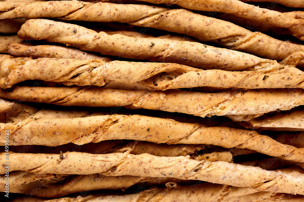 Close up of delicious breadsticks grissini on the wooden table. Italian appetizers. Top view Close up of delicious breadsticks grissini on the wooden table. Italian appetizers. Top view