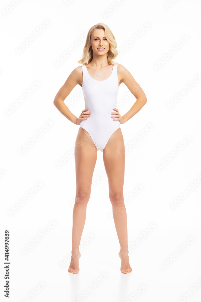 Young, fit and beautiful blond woman in white swimsuit isolated on white. Healthcare, diet, sport and fitness concept. Young, fit and beautiful blond woman in white swimsuit isolated on white. Healthcare, diet, sport and fitness concept.