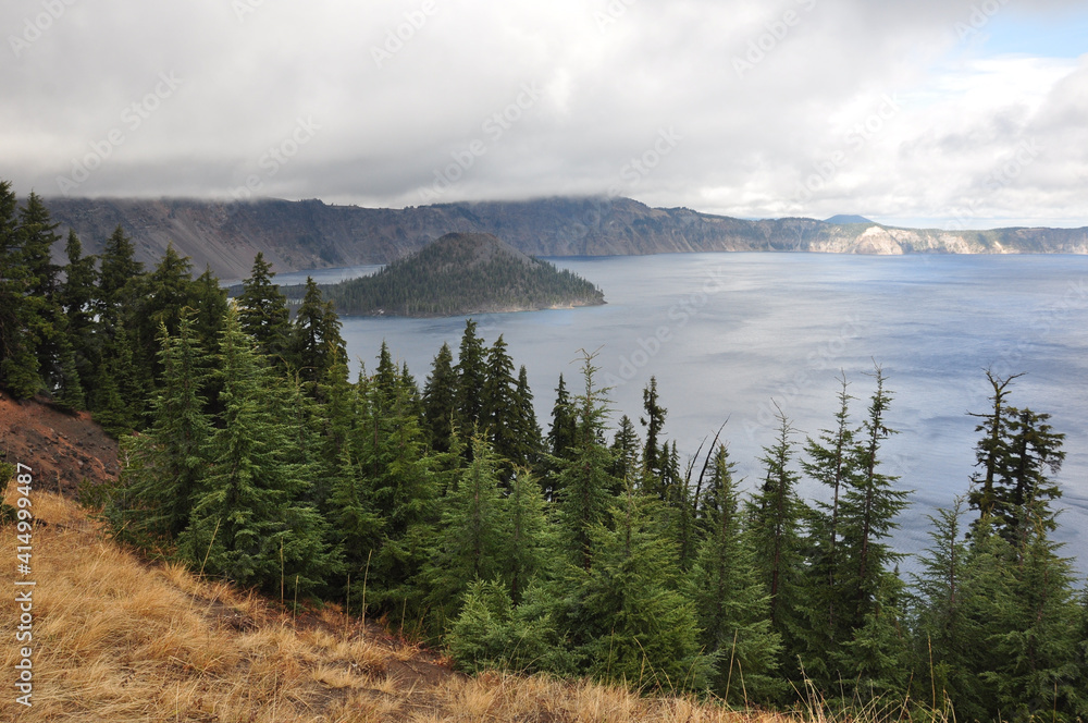 Moody view of Wizard Island in Crater Lake National Park on a cloudy day