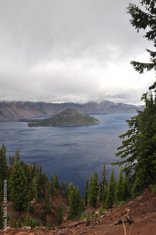 Moody view of Wizard Island in Crater Lake National Park on a cloudy day