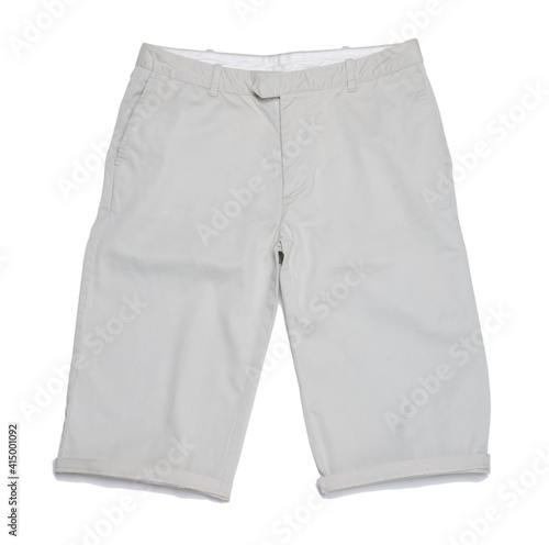 Clothing article, a pair of cream long shorts.
