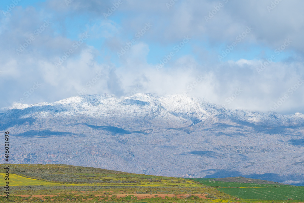 snow capped mountains and farmland in Ceres, South Africa during Winter season
