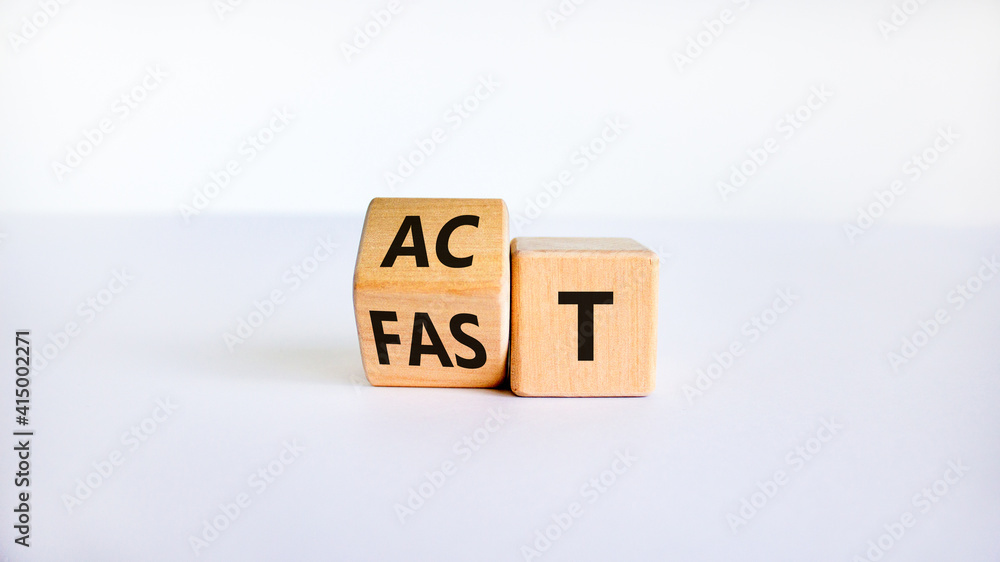 Time to act fast symbol. Turned a wooden cube with words 'act fast'. Beautiful white table, white background, copy space. Business and act fast concept. Time to act fast symbol. Turned a wooden cube with words 'act fast'. Beautiful white table, white background, copy space. Business and act fast concept.