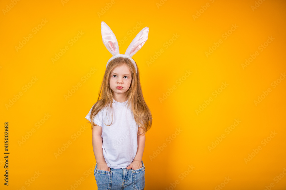 Child with bunny ears, easter bunny on yellow background Child with bunny ears, easter bunny on yellow background