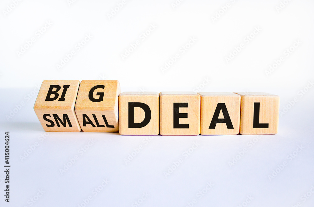 Big or small deal symbol. Turned wooden cubes and changed words 'small deal' to 'big deal'. Beautiful white table, white background, copy space. Business and big or small deal concept. Big or small deal symbol. Turned wooden cubes and changed words 'small deal' to 'big deal'. Beautiful white table, white background, copy space. Business and big or small deal concept.