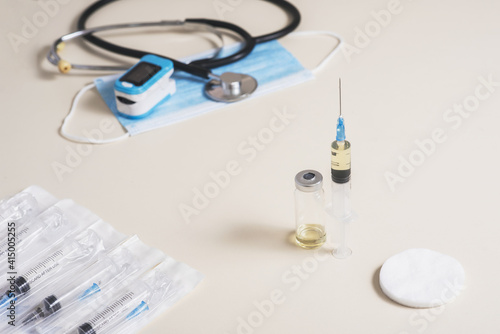 Vaccine readiness. Syringe with vaccine and necessary elements for diagnosis and vaccination