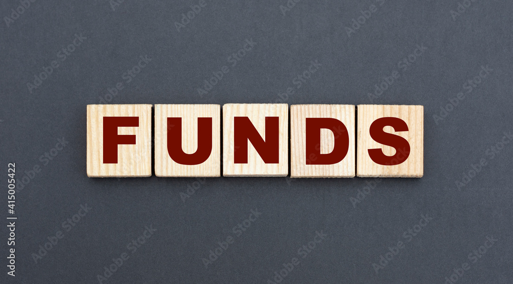 concept word FUNDS on wooden cubes on a gray background concept word FUNDS on wooden cubes on a gray background
