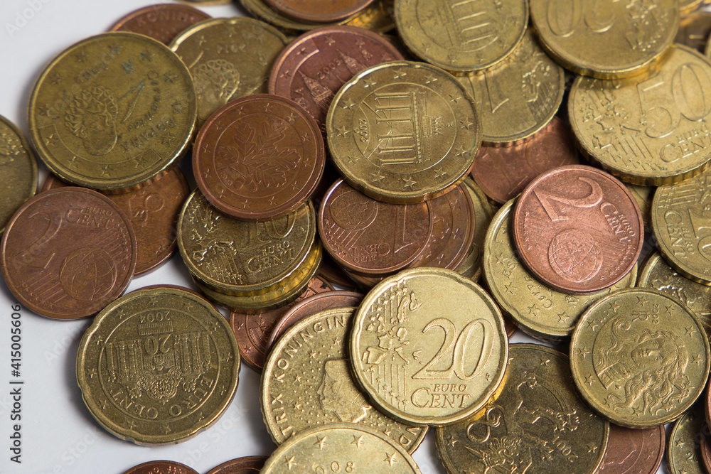 Coins scattered on the table. White background. Finance. Coins scattered on the table. White background. Finance.