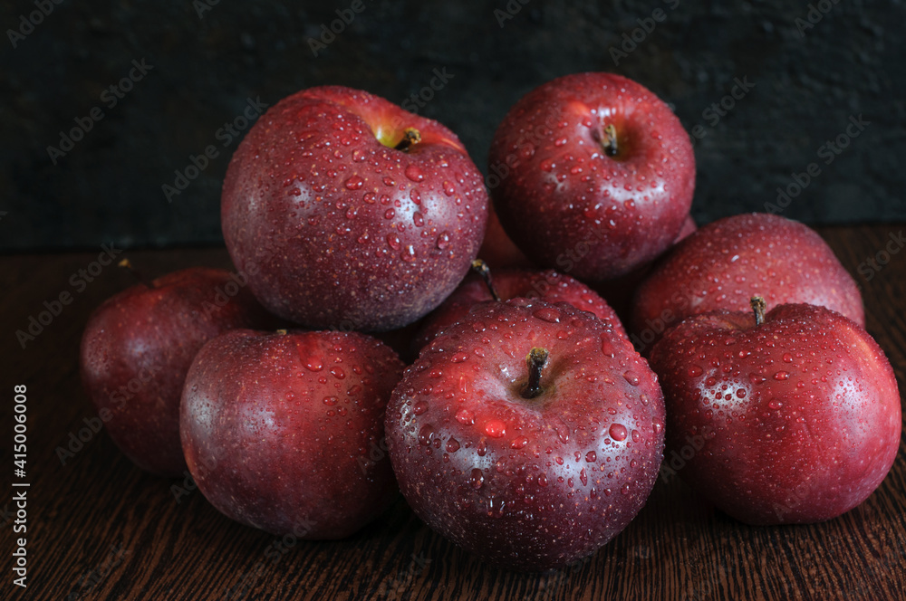 Slide of red ripe apples with water drops on a dark background. Selective focus. Close-up Slide of red ripe apples with water drops on a dark background. Selective focus. Close-up