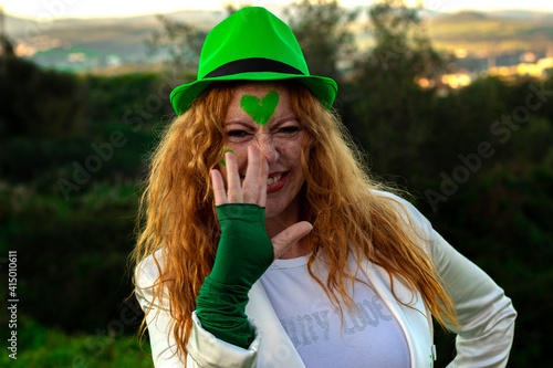 red-haired Irish woman in green cap on St. Patrick's Day 