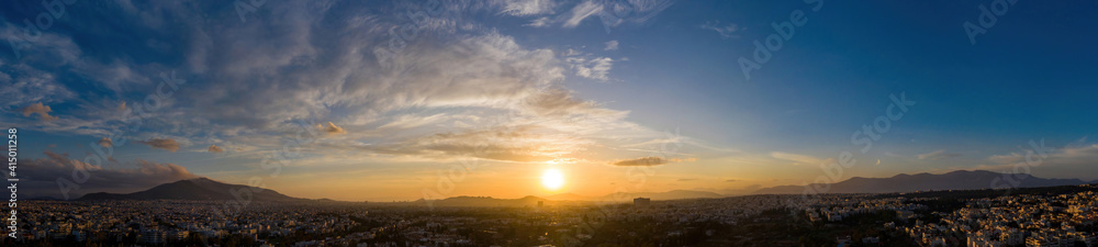 Sunset over Athens, Greece. Aerial drone panoramic view from Penteli mount.