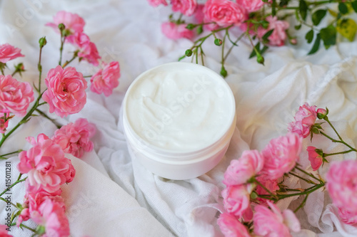 Face and body cream with pink roses on white
