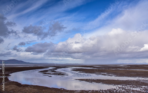 Clouds over sandy beach photo