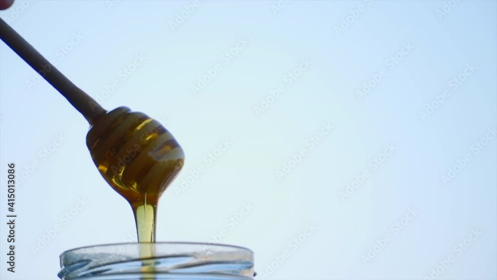 close up of some honey from a honey dipper close up of some honey from a honey dipper