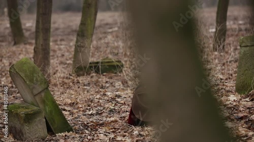 Wallpaper Mural girl in a red coat in an abandoned cemetery at the grave Torontodigital.ca
