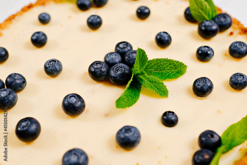 homemade cheesecake decorated with blueberry berries and mint leaves. Cooking desserts and cakes. Confectionery. homemade cheesecake decorated with blueberry berries and mint leaves. Cooking desserts and cakes. Confectionery.