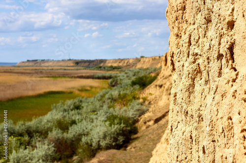 Landscape view of grass and trees on clay cliffs from above